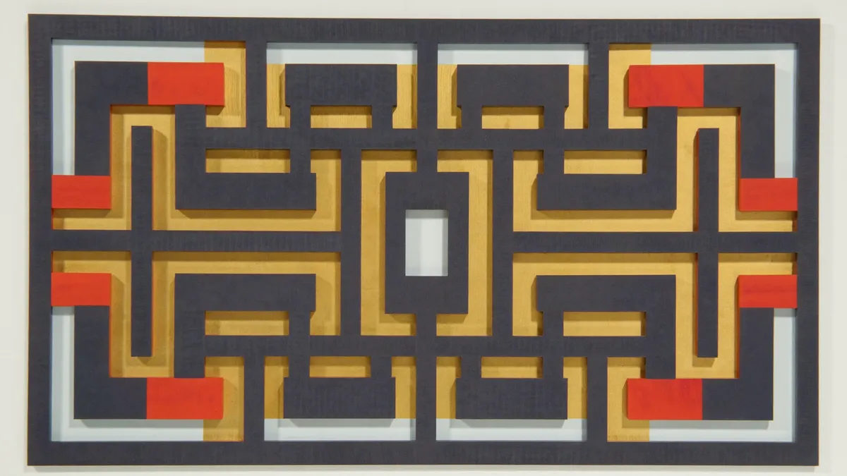 A backlit navy fretwork screen