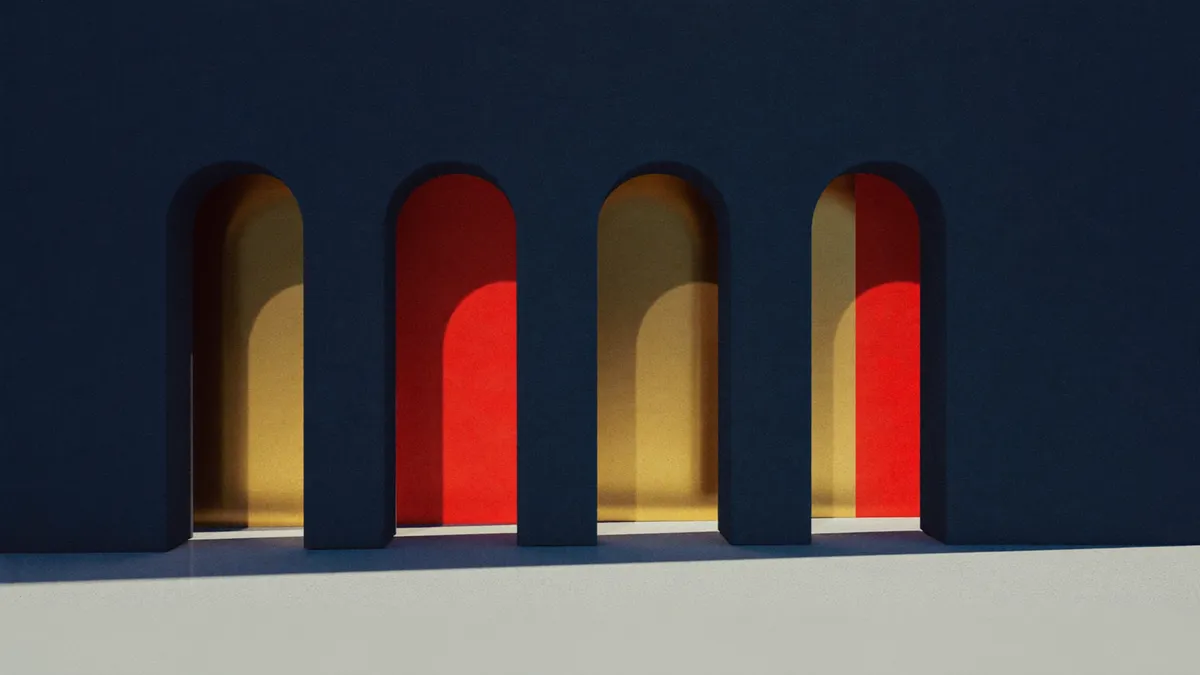 Sunlight and long shadows through a row of stone arches