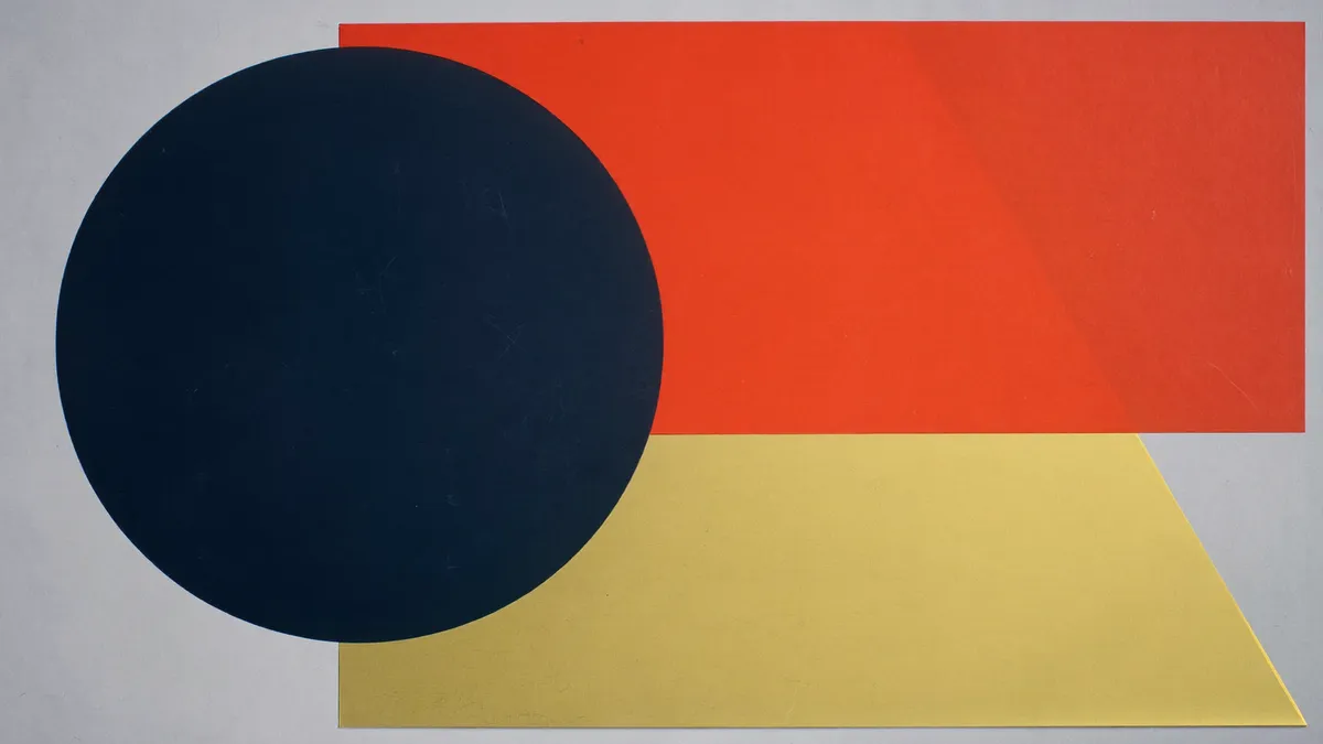 A navy circle overlapping vermilion and brass planes